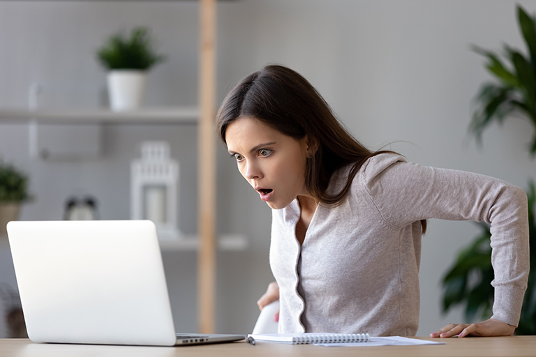 Woman confused while looking at the computer