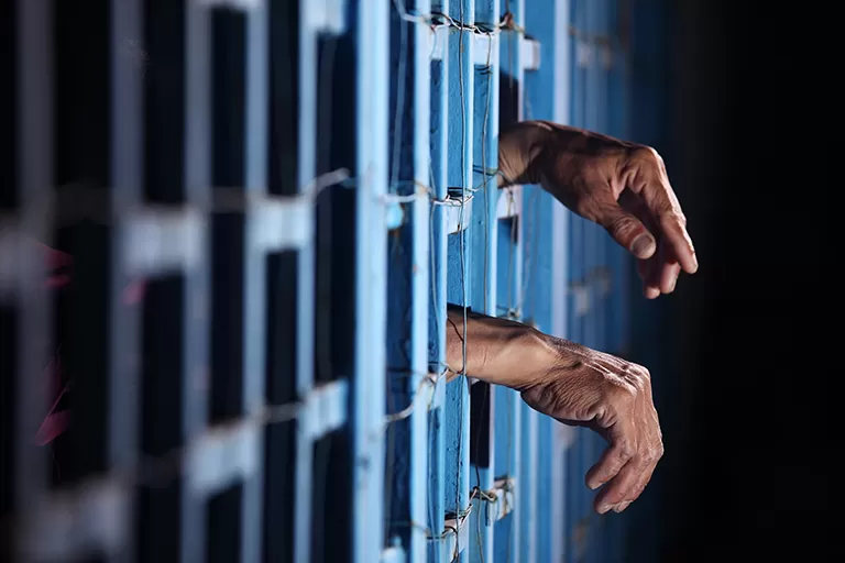 Hands behind bars