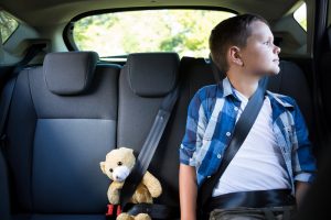 child at the backseat of car